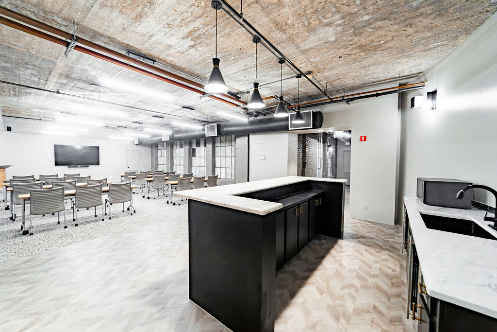 Industrial-chic meeting room with exposed brick and modern AV at The District at Hogg Palace downtown Houston